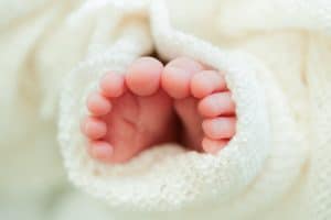 Baby toes wrapped in a blanket