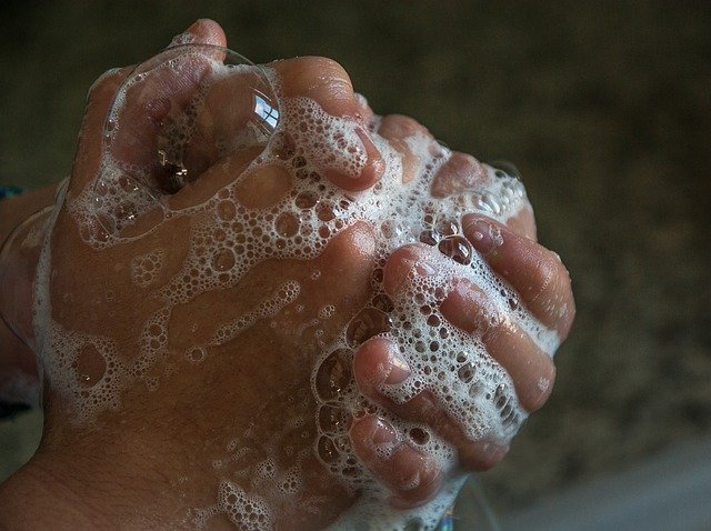 hands rubbing soap suds